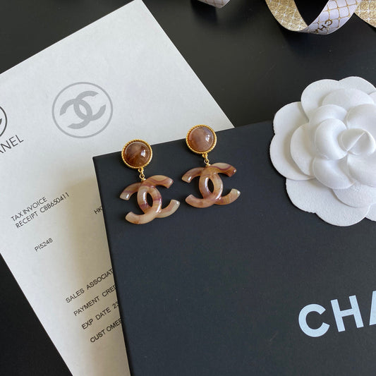 Boucles d'oreilles pendantes logo ambre vintage