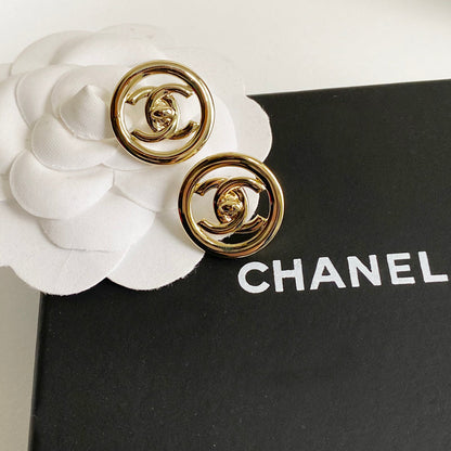 Boucles d'oreilles créoles logotées en métal doré