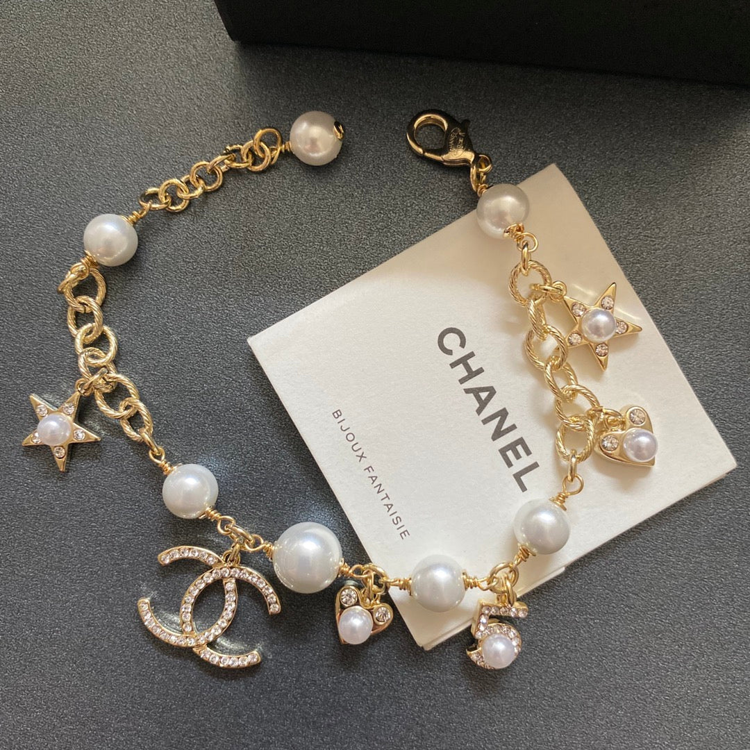 Pulsera con colgante de estrella, corazón y perla