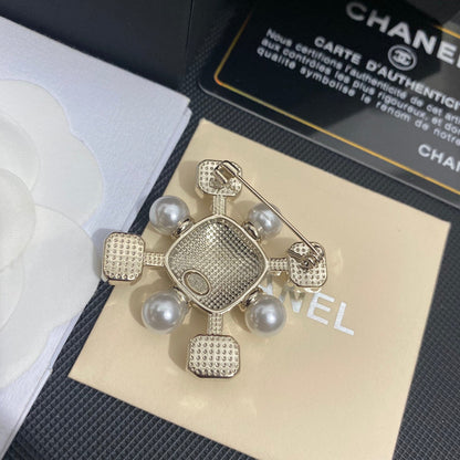 Broche élégante en pierres précieuses et perles