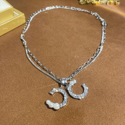 Doble collar con inicial de diamantes