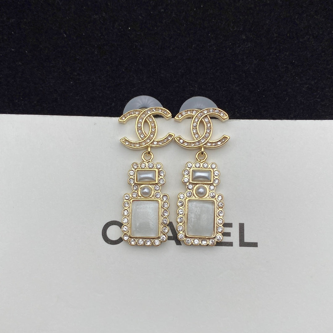 Boucles d'oreilles pendantes élégantes en forme de flacon de parfum