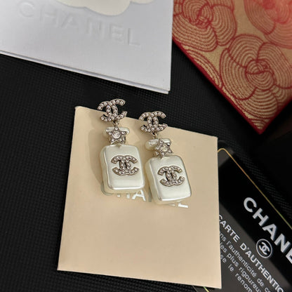 Boucles d'oreilles pendantes flacon de parfum blanc