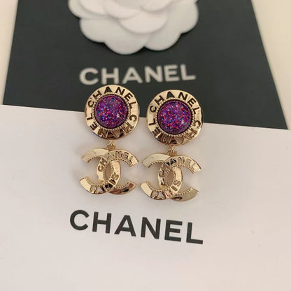 Pendientes de bola morada a la moda