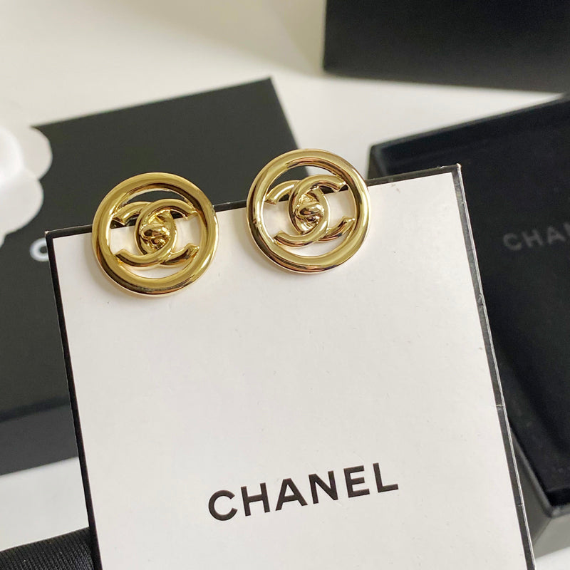 Boucles d'oreilles créoles logotées en métal doré
