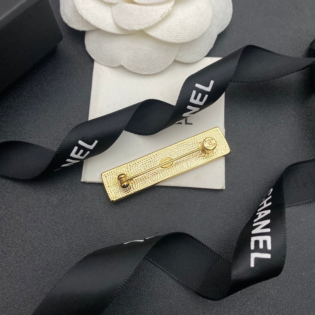 Broche en forme de lettre et de bande